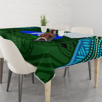 Green Aboriginal pattern tablecloth with teal/blue border and dark animal silhouettes