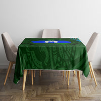 Green Aboriginal pattern tablecloth with blue oval motif, placed on small dining table