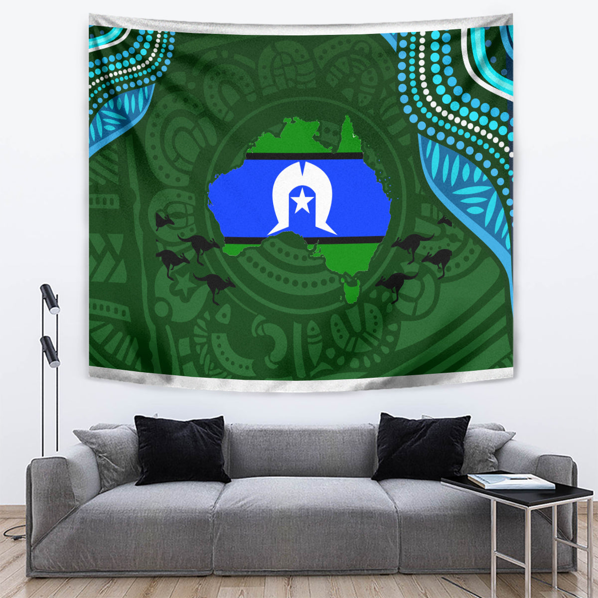 Green Aboriginal pattern tapestry with central star and animal silhouettes, wall drape over sofa