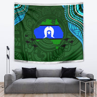 Green Aboriginal pattern tapestry with central star and animal silhouettes, wall drape over sofa