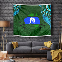 Green Aboriginal pattern tapestry with central star and animal silhouettes, on wall above couch