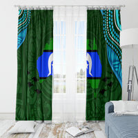 Green window curtain panels with blue stripe and white star emblem, shown with top grommets.
