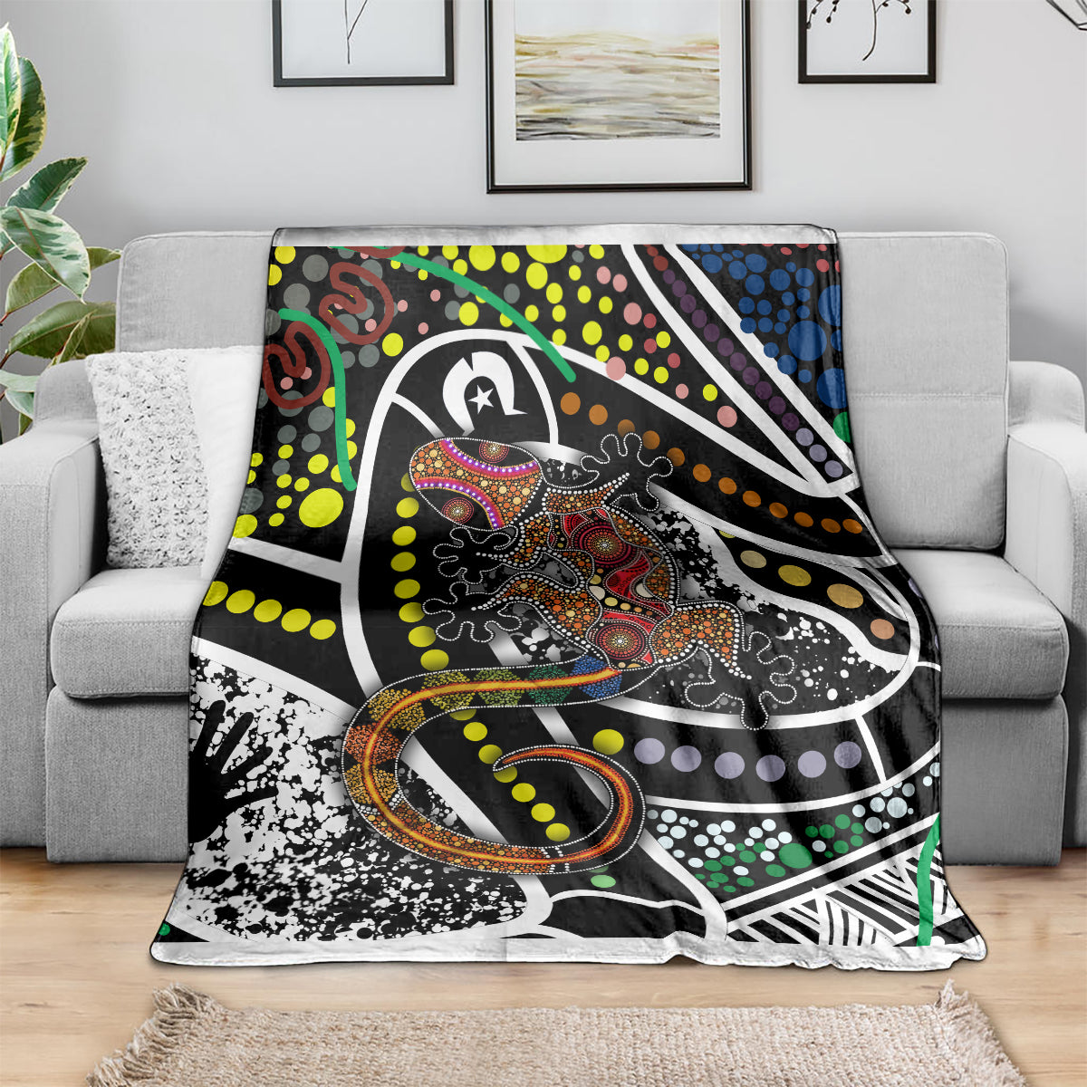 Lizard dot art blanket with black, white, green, yellow, orange, and purple geometric shapes