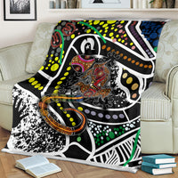 Lizard dot art blanket draped on a sofa, featuring multicolor dot bands and accents