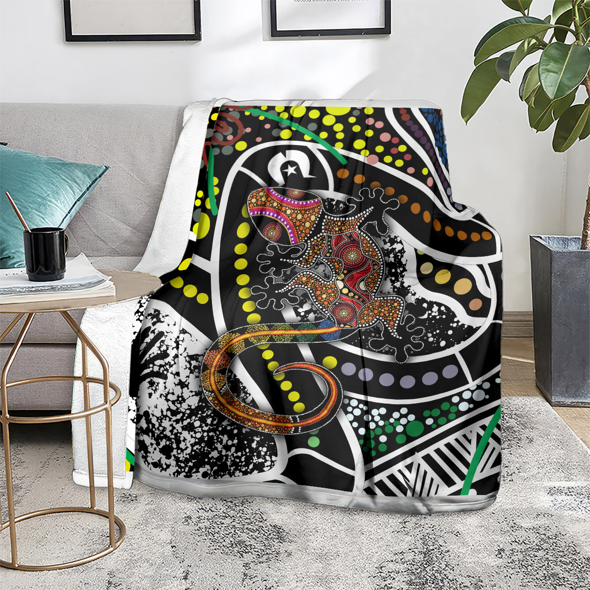 Lizard dot art blanket on the floor, bold black design with multicolor dots and swirls