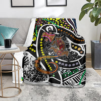 Lizard dot art blanket on the floor, bold black design with multicolor dots and swirls