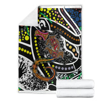 Lizard dot art blanket folded stack, multicolor lizard motif on black and white background