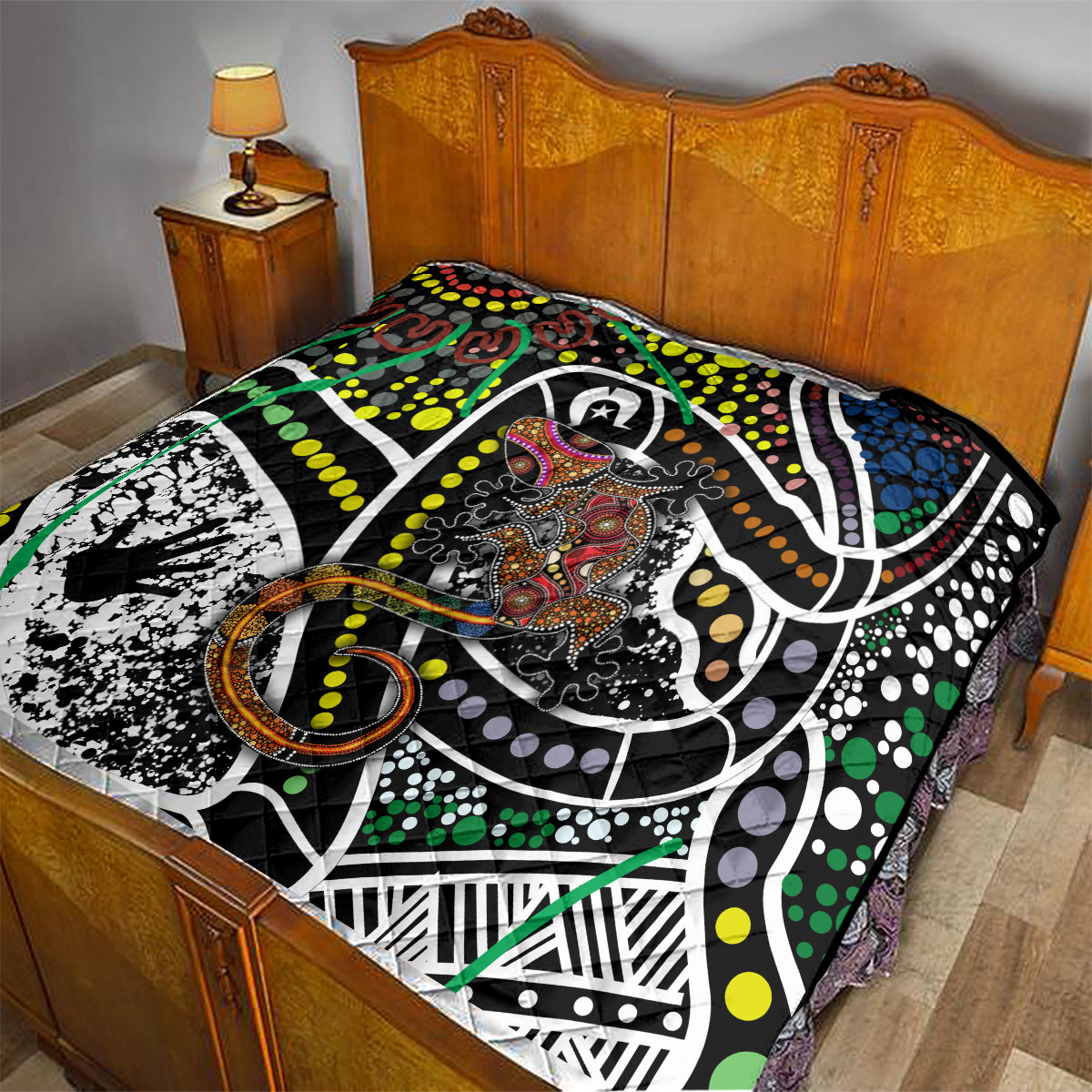 Multicolor Aboriginal lizard pattern dot art quilt on a bed with matching design