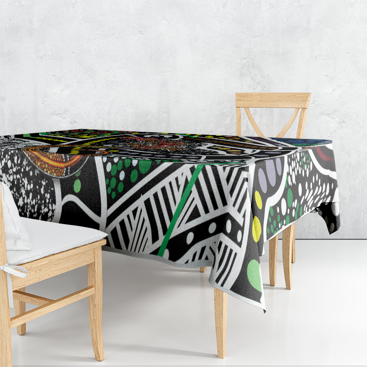 Abstract multicolor tablecloth with black base, white motifs, green dots, and orange border accents