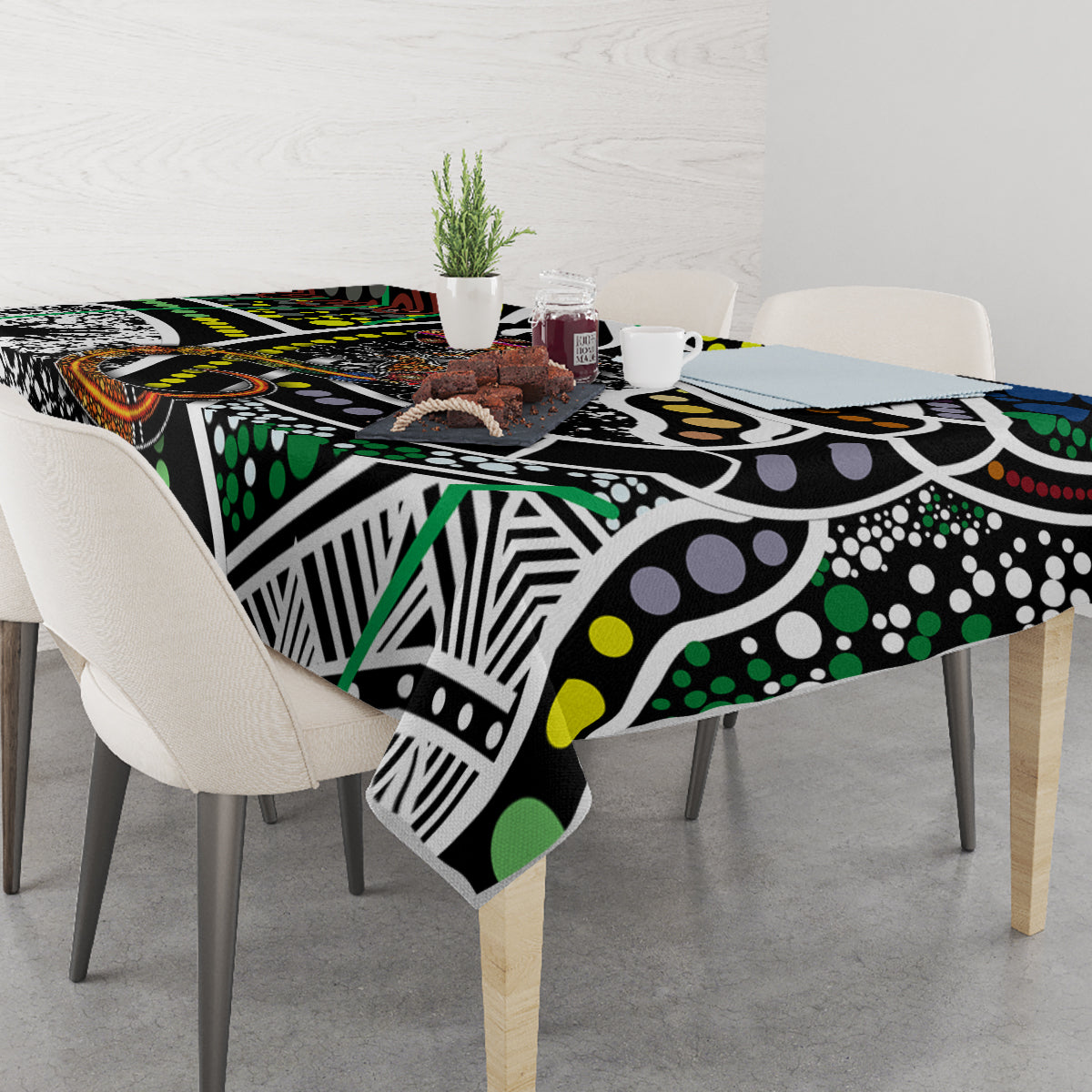 Multicolor patterned tablecloth with black, green, yellow, white, and orange dot and line motifs