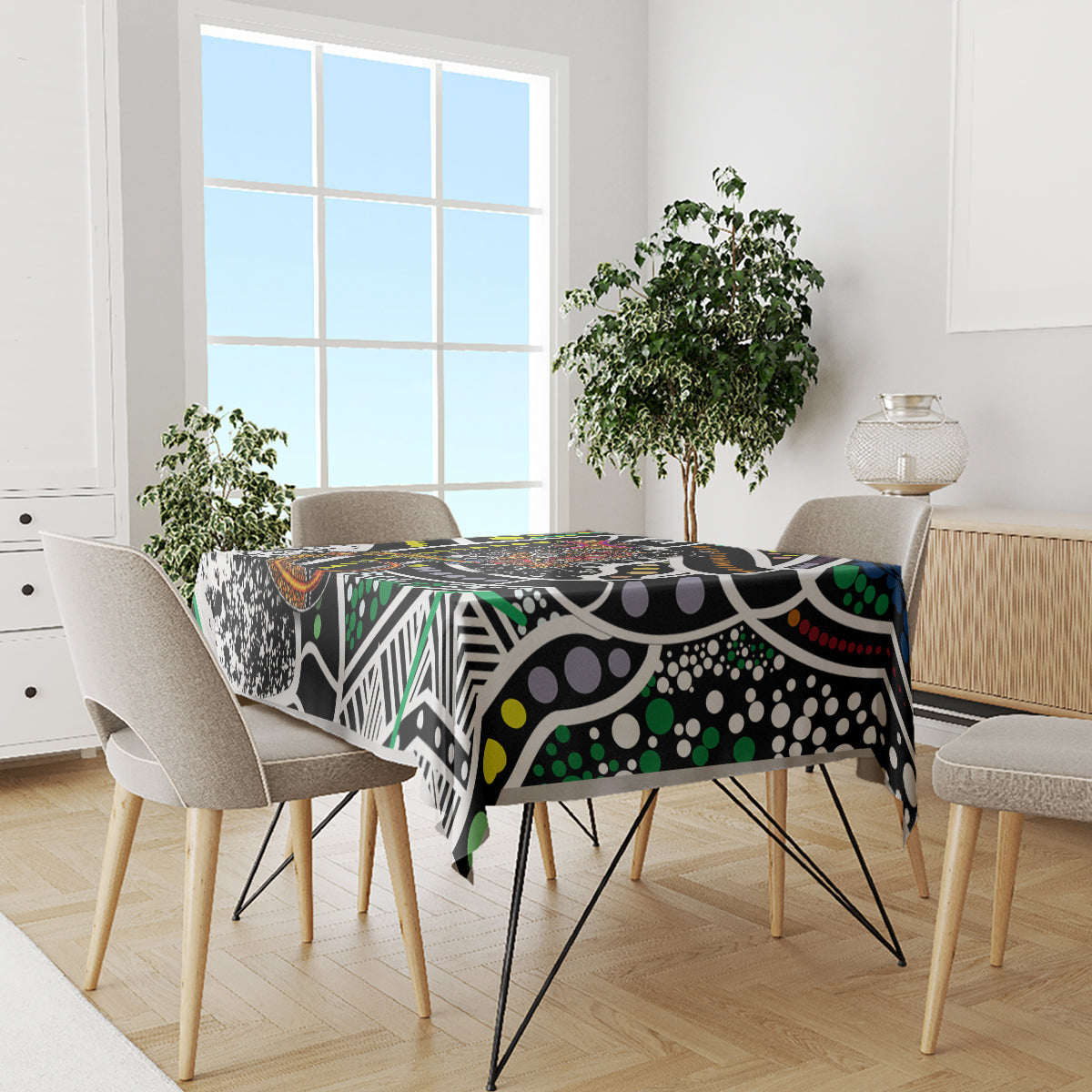 Multicolor abstract tablecloth with black base, white shapes, green dots, and orange accents