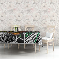 Multicolor patterned tablecloth featuring black, white, green, and orange circular dot details