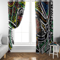 Multicolor Aboriginal dot art window curtains with top rod header, set over a white window.