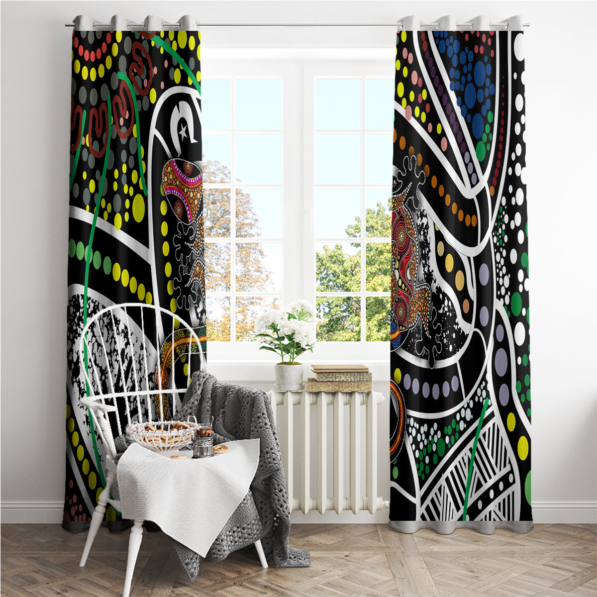 Multicolor Aboriginal dot art window curtains with patterned borders, hanging in a sunlit room.