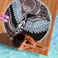Round beach blanket with fringe edge, multicolor bird pattern on black, shown from above.