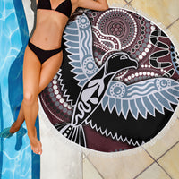 Round beach blanket with fringe edge, multicolor Aboriginal-style bird pattern, laid on pool deck.