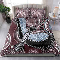 Maroon bedding set with large bird graphic in black and light blue, plus two pillowcases