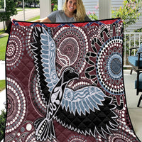Burgundy bird pattern quilt with black, white and light-blue Aboriginal-style circular motifs