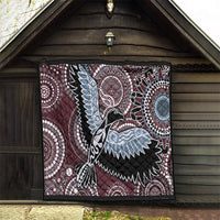 Rectangular burgundy quilt with Aboriginal-style bird and dotwork circles in light blue and white