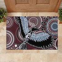 Rectangular rubber doormat with Aboriginal-style bird in maroon, black, light blue, and white