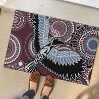 Rubber entry mat with Aboriginal-style bird illustration and dotwork circles in maroon and blue