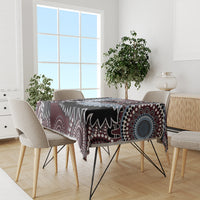 Bird-pattern tablecloth on dining table with maroon, black, blue, and white Aboriginal motifs.