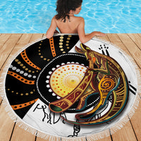 Round fringed beach blanket with kangaroo dot pattern in black, orange, and gold tones