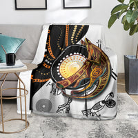 Aboriginal kangaroo pattern dot art blanket laid on chair, white background with dark accents