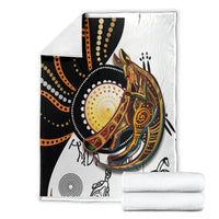 Folded Aboriginal kangaroo pattern dot art blanket with stacked white cloths, kangaroo center design