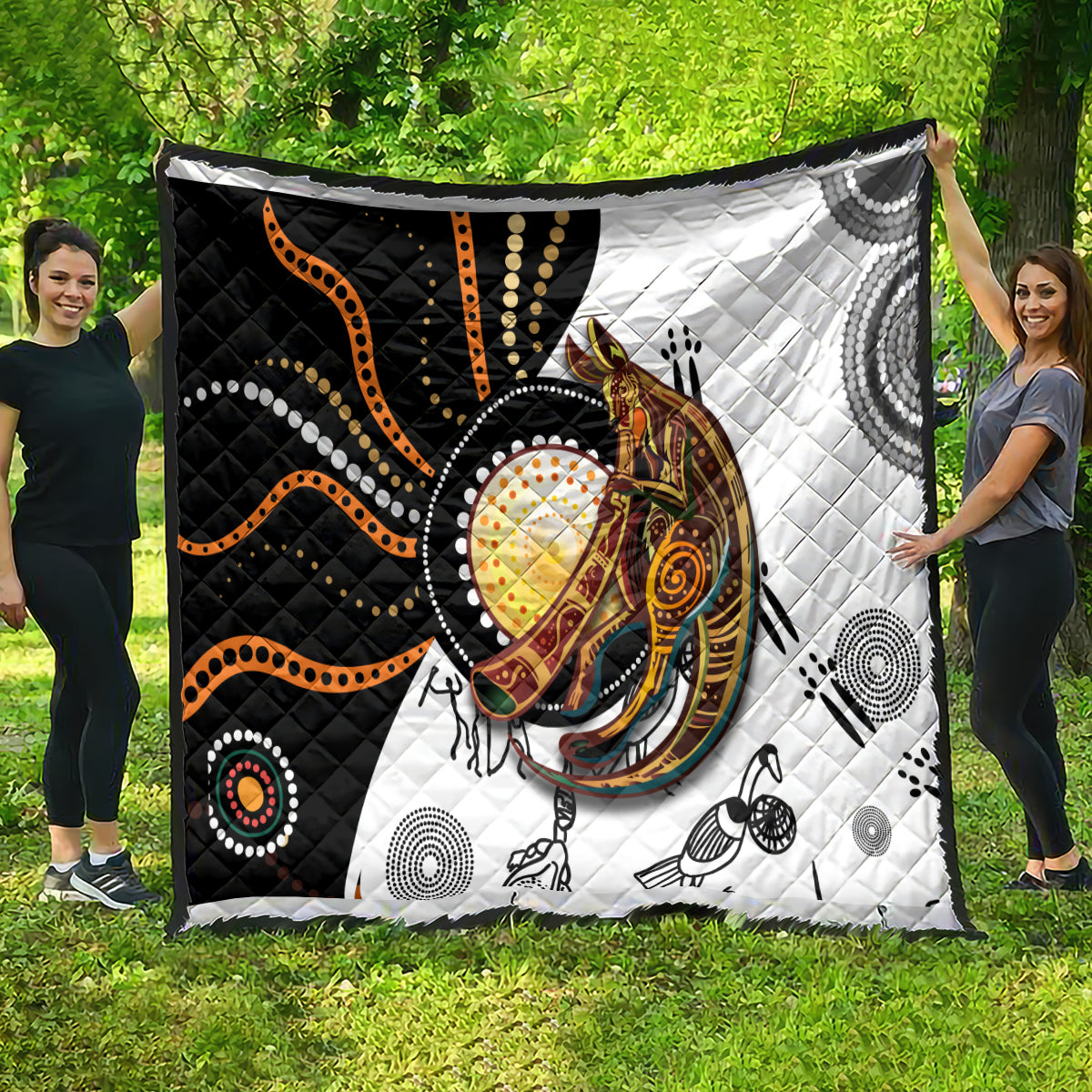 Quilt with quilted diamond stitching and black, white, orange Aboriginal kangaroo pattern