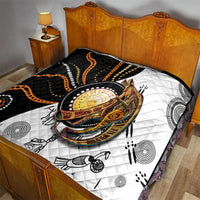 Quilt spread on bed with black-and-white kangaroo design and orange dotted accents