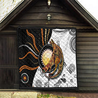 Quilt with black, white, and orange dotted kangaroo design in quilted patchwork blocks