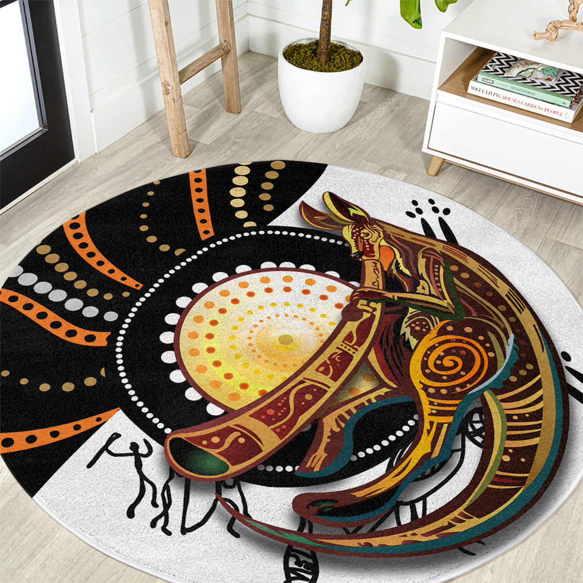 Round rug with dot and kangaroo artwork in black, orange, and gold