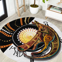 Round rug with dot and kangaroo artwork in black, orange, and gold