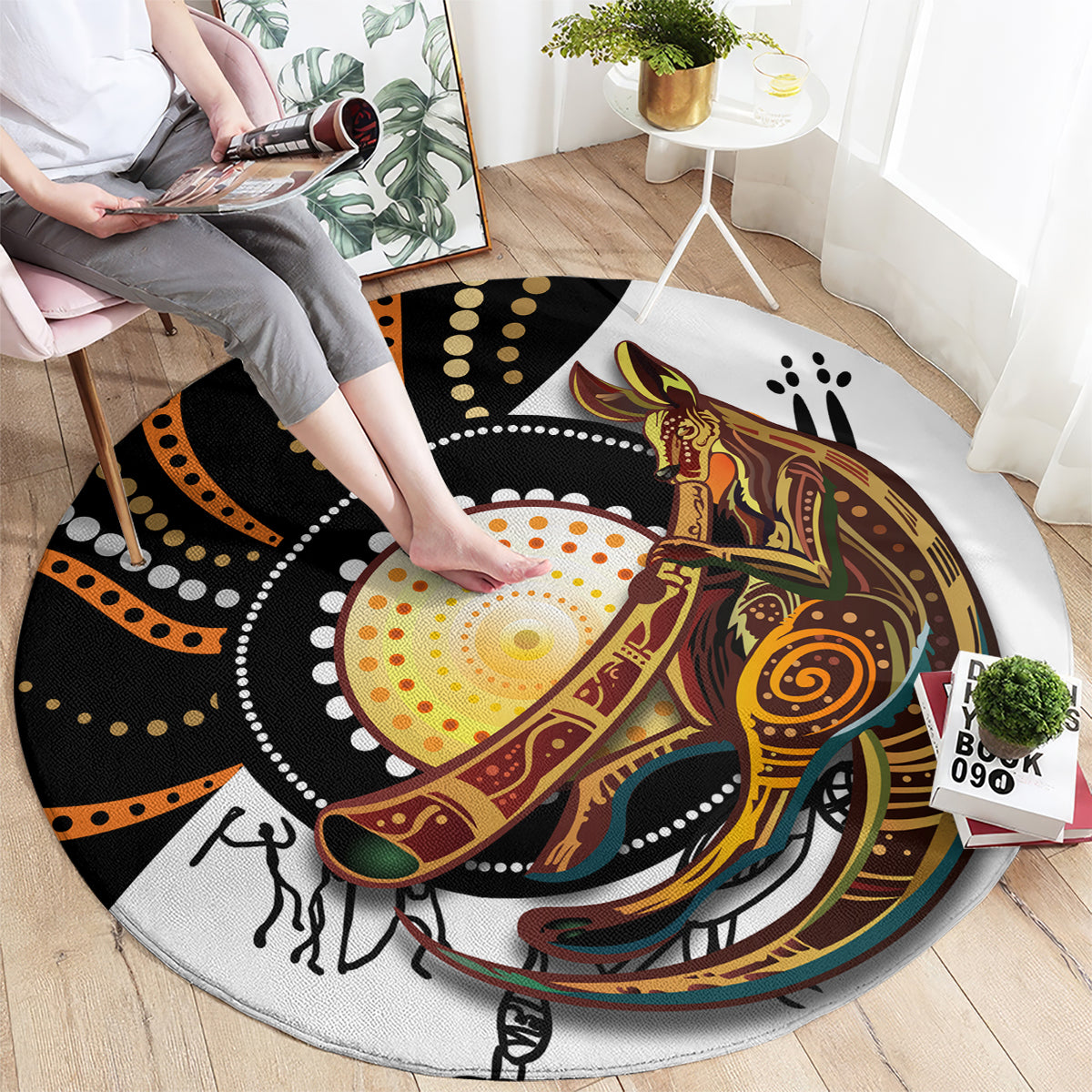 Round rug with black, orange, yellow dotwork and kangaroo graphic, full view