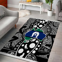 Abstract map-pattern area rug with bold black, white, blue and green center motif.