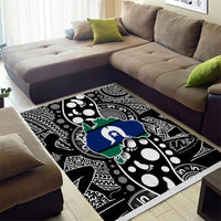 Abstract tribal map-pattern area rug in black and white with blue and green accents.