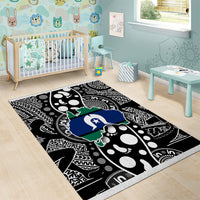 Abstract map-pattern area rug with black, white, blue and green design and border.