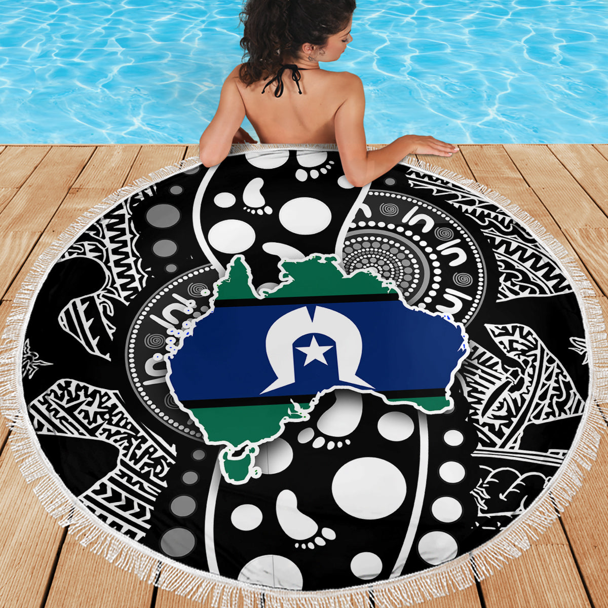 Round beach blanket with white fringe edge, blue Australia map over black dot pattern