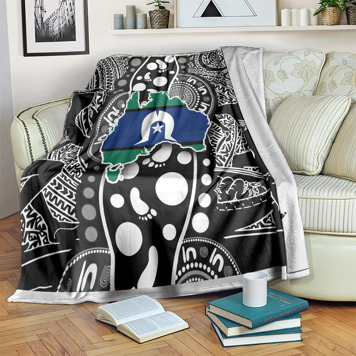 Aboriginal pattern blanket draped over sofa, black base with white dots and blue-green map