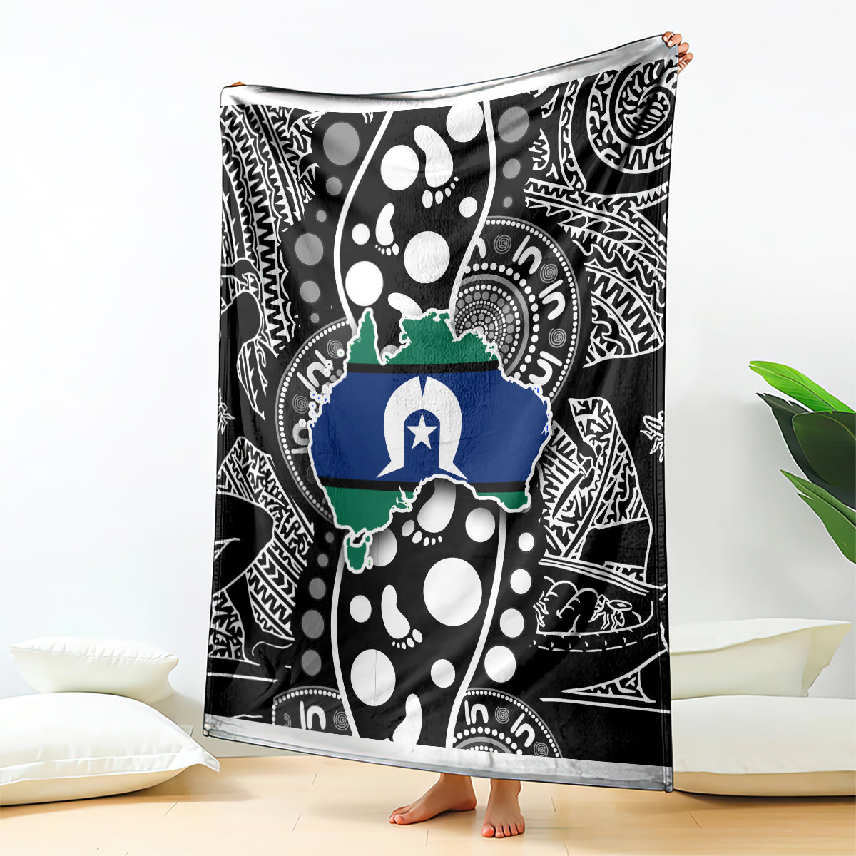Aboriginal pattern blanket hanging on floor, black and white with blue and green map design