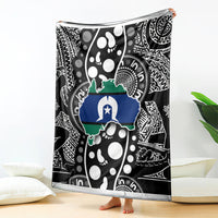 Aboriginal pattern blanket hanging on floor, black and white with blue and green map design