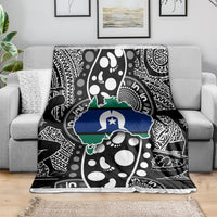 Aboriginal pattern throw blanket on gray sofa, black and white with blue-green Australia outline