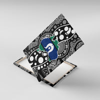 Canvas wall art angled on a stand, featuring black patterns and a blue island map with white star