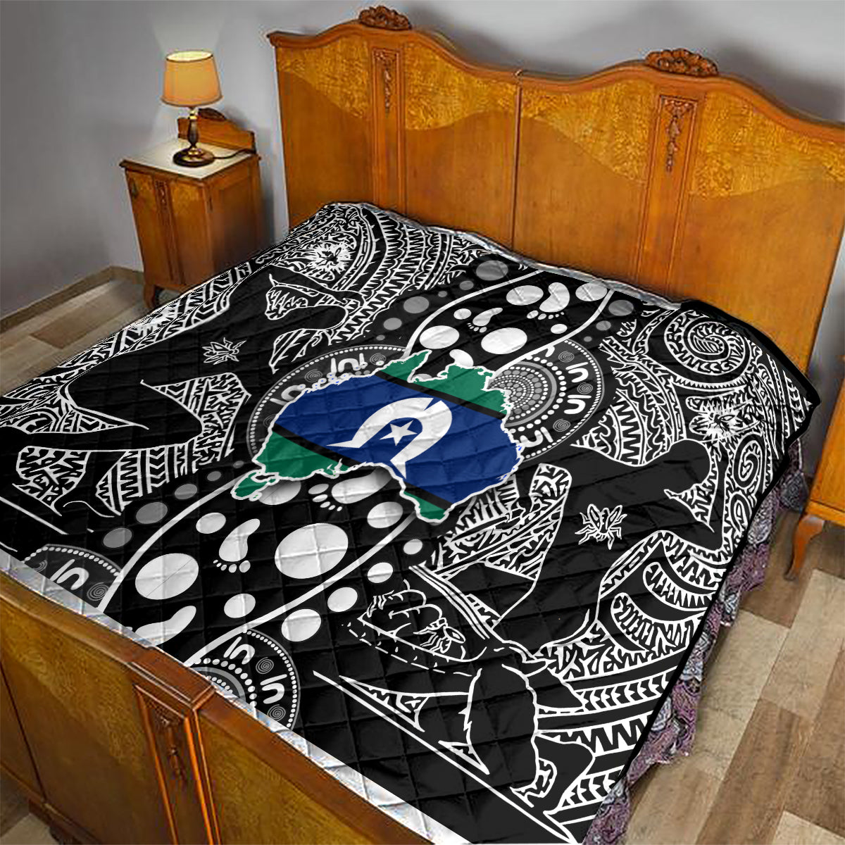 Aboriginal pattern quilt on bed, black-and-white tribal print with blue star and green map