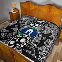 Aboriginal pattern quilt on bed, black-and-white tribal print with blue star and green map