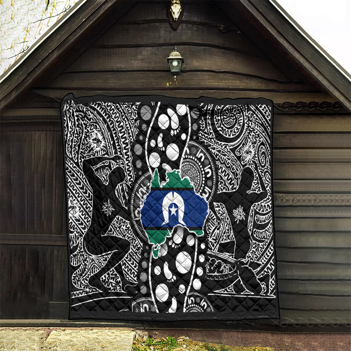 Aboriginal pattern quilt hanging on wall, black-and-white tribal print with blue star map