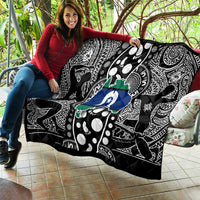 Aboriginal pattern quilt held up outdoors, black-and-white tribal motifs with blue star and green
