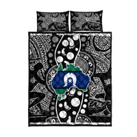 Quilt bed set with two matching pillows, black and white patterns with blue and green emblem
