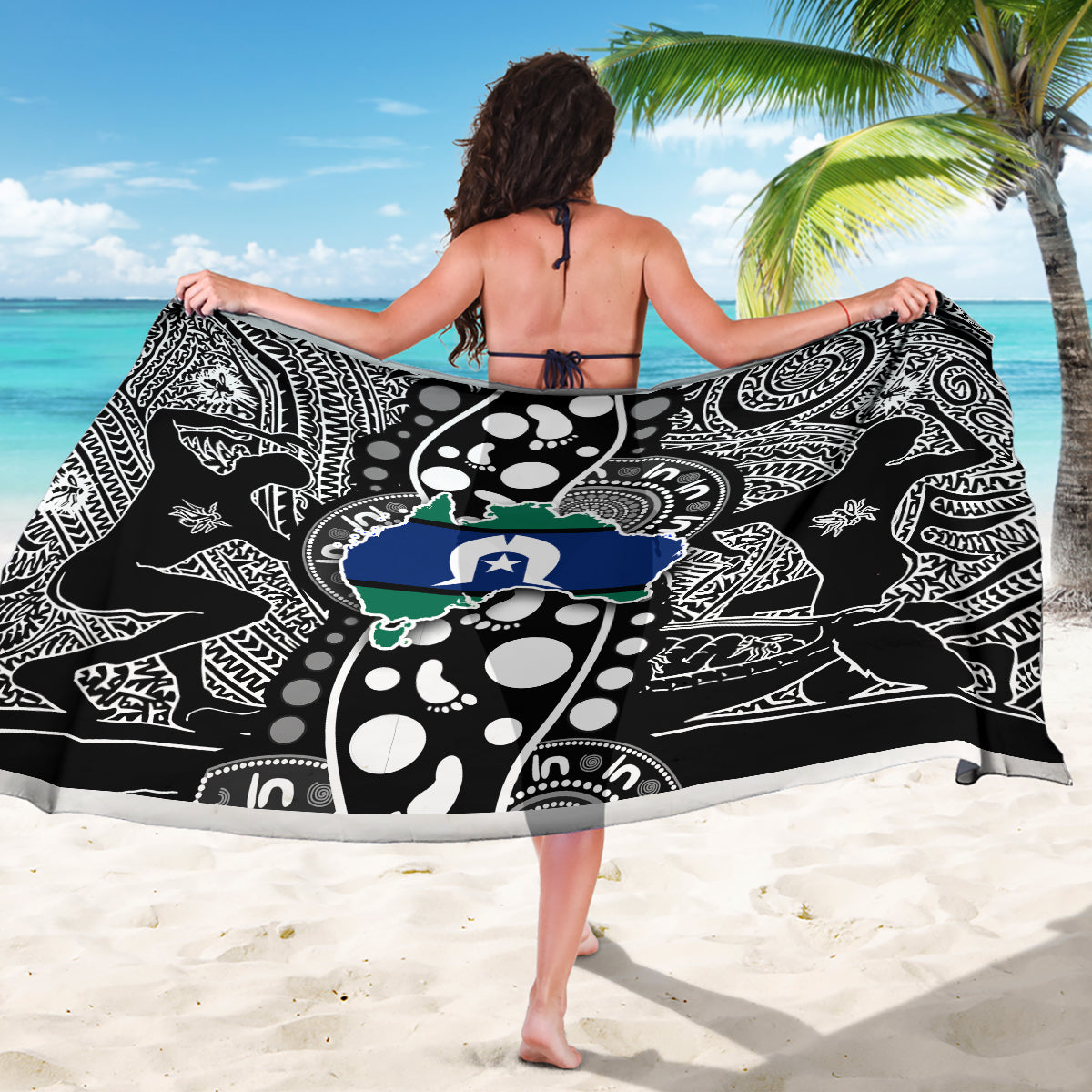 Black and white sarong with map motifs, worn as a beach wrap
